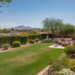 A lush, colorful Chandler yard in the spring with blooming flowers and a green lawn.