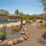 A fire-resistant poolside landscape in Mesa with succulents, gravel, and stone features